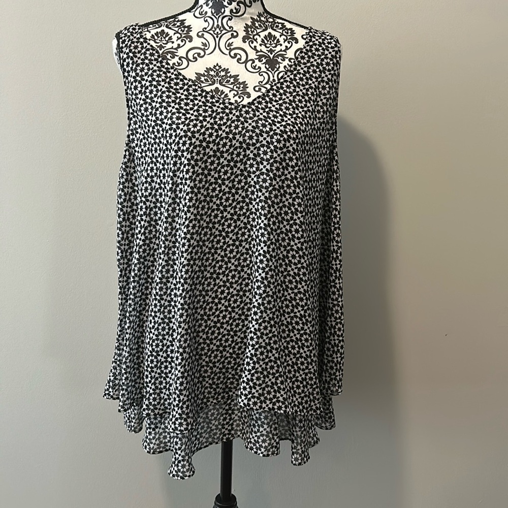 Woman’s double v-neck tiered layer tank with black and white circle pattern.